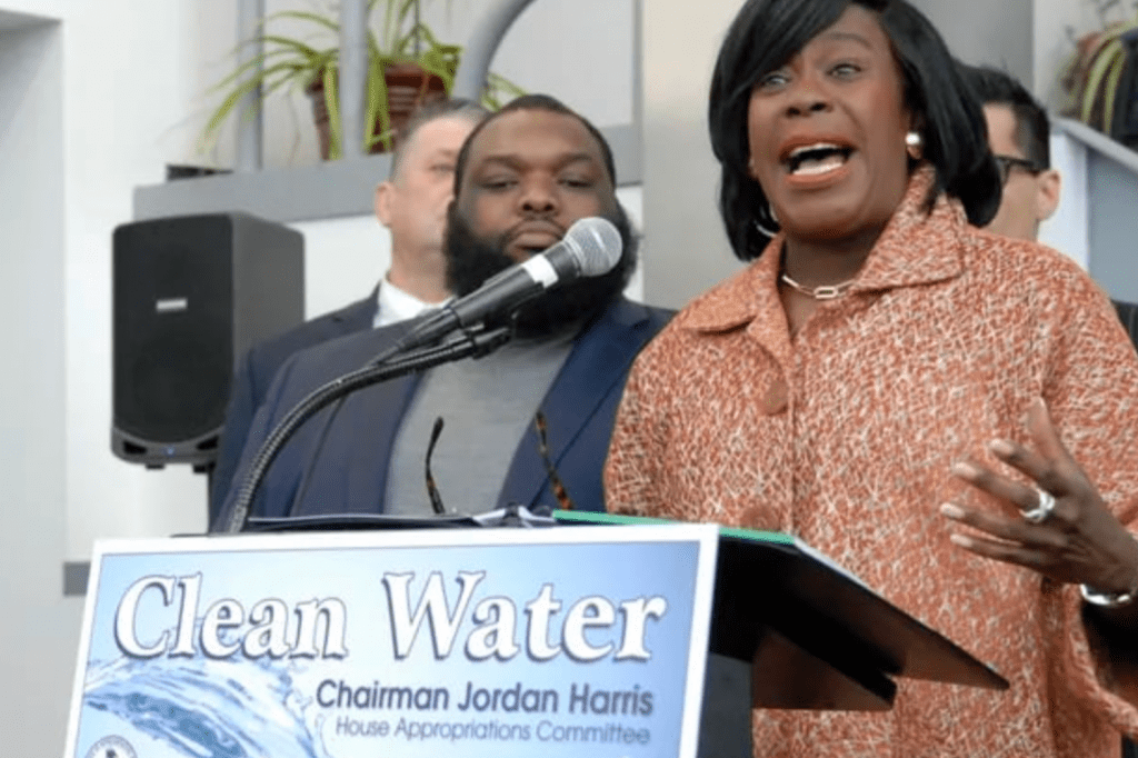 Philadelphia Mayor Cherelle Parker speaking at a podium with a sign that says "Clean Water"